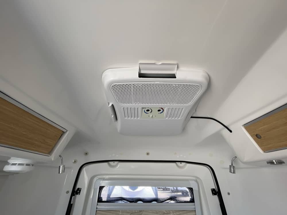 Ceiling-mounted A/C unit with overhead bamboo storage cabinets