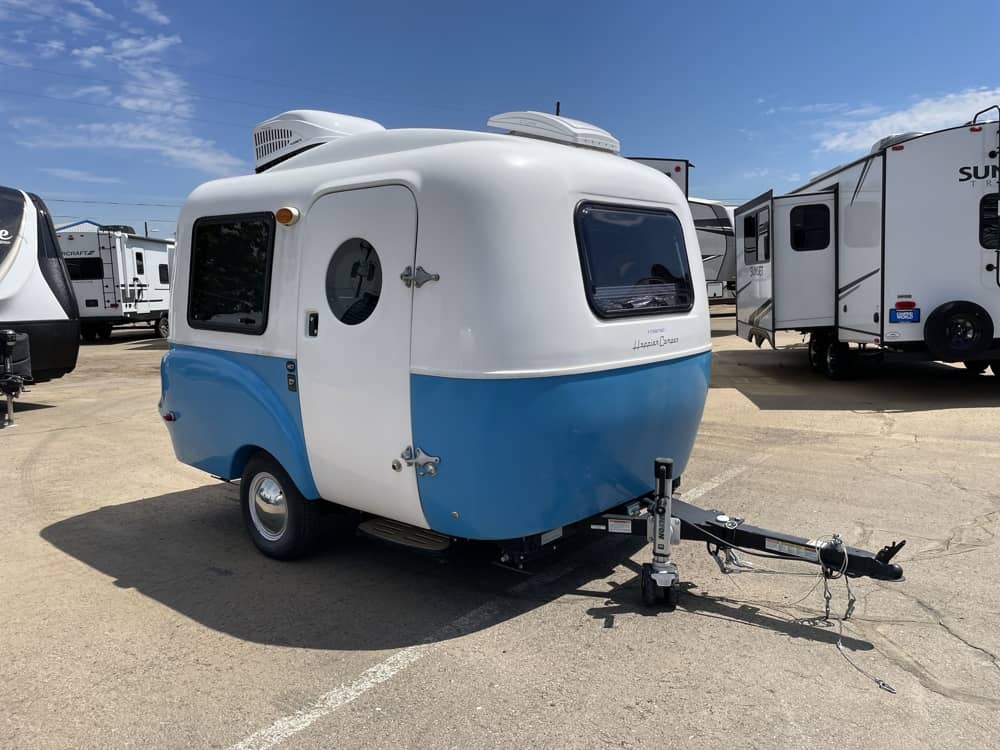Exterior — door side view showing porthole window, entry, and blue/white paint