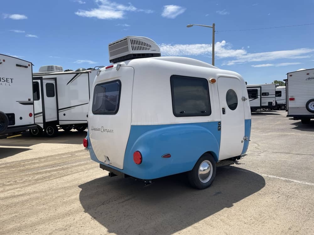 2022 Happier Camper HC1 Premium — rear/passenger side exterior showing A/C unit, rear window, and porthole door